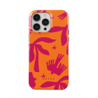 orange case with pink trees and birds design on case placed on phone