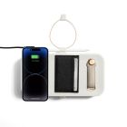 iphone charging on box with pencil on the side attached and wallet card on top