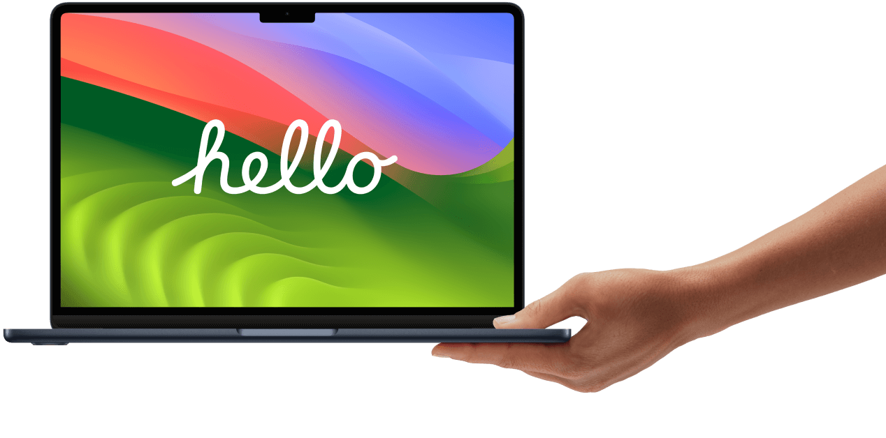 Persons hand holding MacBook