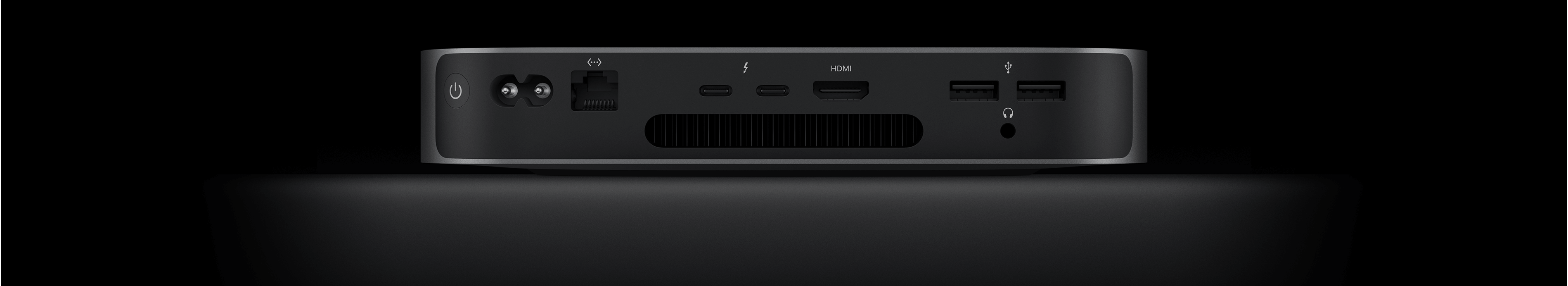 Back view of Mac mini showing the two Thunderbolt 4 ports, HDMI port, two USB-A ports, headphone jack, Gigabit Ethernet port, power port, and power button.